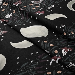Close-up of bohemian moon phase tapestry showing floral details and textile texture