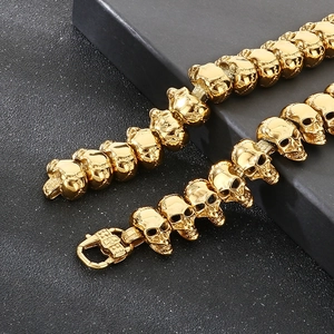 Detailed view of a golden punk skull bracelet with intricate carvings on black box