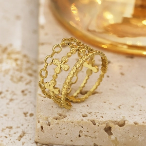 Detail of 18k gold plated stainless steel multi-layer ring with hollow textures