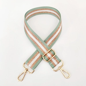Detail of adjustable mint green and gold striped nylon strap with gold metal hooks