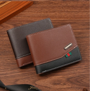 Close-up of men's short wallets with vintage patchwork and contrast stitching on wood