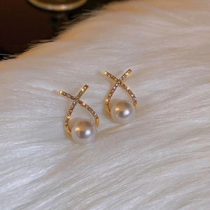 Detailed view of gold cross-shaped stud earrings with zircon inlay and hanging white pearl