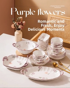 Detailed view of purple floral ceramic dinnerware set with bowl and plate on a rustic table