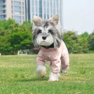 Pink waterproof pet jumpsuit for dogs, lightweight four-leg protective rain suit on grass