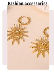 Detailed macro view of 18k gold plated sun pendant earrings with spiral texture pattern