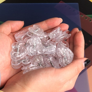 Macro shot of transparent heart-shaped clips showing clear plastic texture and compact size