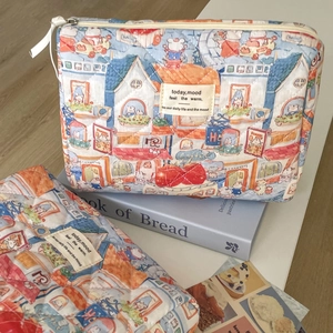 Detailed shot of quilted cotton makeup bags with hand-drawn animal and street illustrations