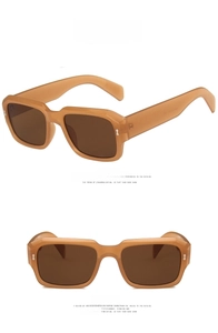 Detail of square oversized jelly tea sunglasses with silver metal rivets on a white background