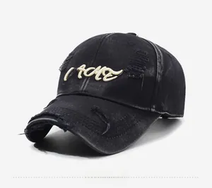Detailed side view of vintage black denim baseball cap with MOLE embroidery and distressed holes
