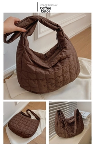 Detail view of coffee brown quilted puffer tote bag with zipper closure and lattice pattern