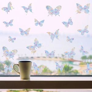 Holographic butterfly window stickers with rainbow prism effect on a bright sunlit glass