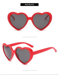 Detailed views of red heart-shaped sunglasses with black polarized lenses from two angles