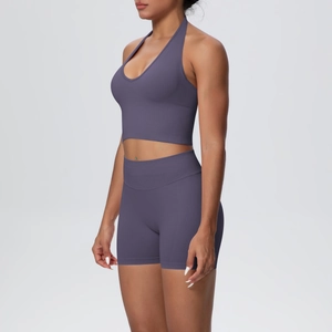 Side view of purple ribbed knit yoga set featuring halter neck top and high waist shorts