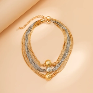 Detail of layered gold and silver mixed chains with metallic beads and lobster clasp