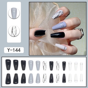 Long ballerina press-on nails with black, white marble patterns and silver lines