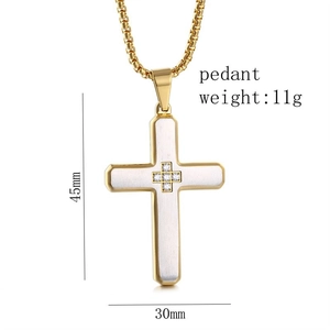 Detailed view of two-tone cross pendant with dimensions 45x30mm and crystal inlay