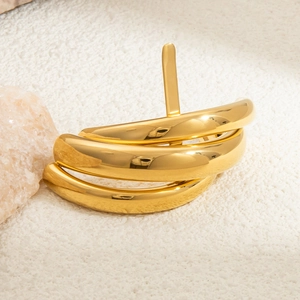 Macro detail of multi-layered 18K gold plated U-shape cuff with polished mirror finish