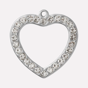 Detail shot of a silver heart pendant featuring hollow design and sparkling rhinestones
