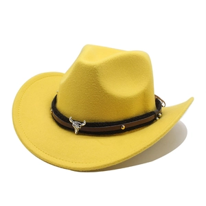 Detail of yellow wool felt cowboy hat featuring a leather band and silver bull head charm