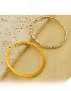 Detail of 18k gold-plated hoop earrings with polished finish and pavé cubic zirconia inlay