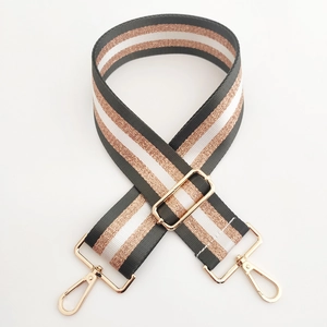 Close-up of 5cm wide striped bag strap with gold metal hooks and adjustable buckle