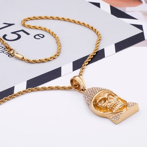 Detail of gold skull pendant with sparkling rhinestones on a twist rope chain