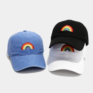 Washed cotton baseball caps with rainbow embroidery in blue, black, and white colors