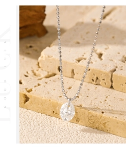 Close-up of S925 sterling silver chain with an oval moissanite gemstone on stone
