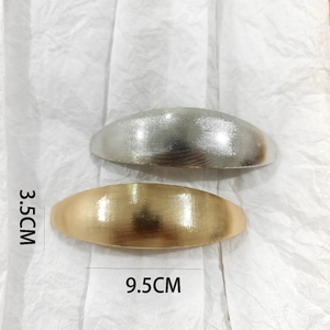 Macro detail of alloy hair clips with brushed texture and metal finish, 9.5cm length