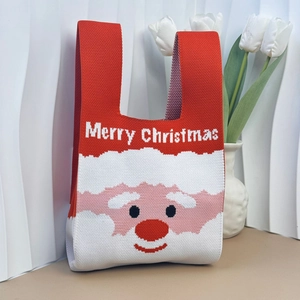 Close-up of knitted Christmas tote bag featuring Santa Claus pattern and text detail