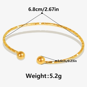Detail of 18k gold open bracelet with hammered texture and size dimensions in inches