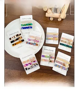 Three-piece acetate hair clip set featuring marble and tortoiseshell patterns on display card