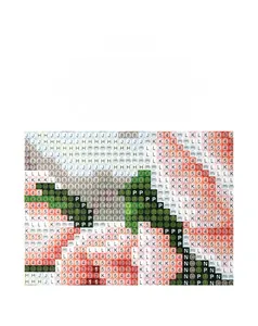 Macro detail of diamond painting canvas showing clear symbol grid for DIY craft kits