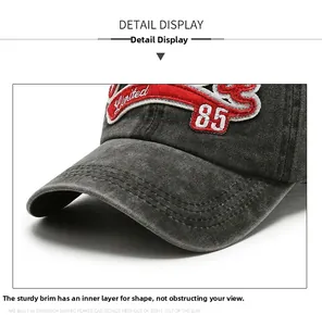 Close-up of vintage washed denim baseball cap with red Limited 85 embroidery detail
