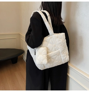 Detail of white quilted tote bag with floral embroidery and matching small coin purse