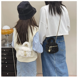Rear view of model wearing mini plush quilted chain bag in white and black faux fur