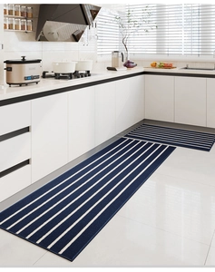 Blue and white striped kitchen mat set on modern white tile floor in bright kitchen