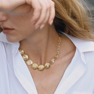 Elegant 18K gold plated stainless steel necklace with round pearl swirls on a model