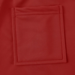 Macro detail of high-quality red cargo pants showing precise stitching on the side pocket