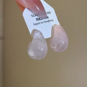 Detailed view of pink resin teardrop earrings on a silver card holder for daily wear