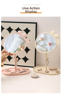Close-up of pink and cream bow desktop mirror with oval jewelry storage tray base