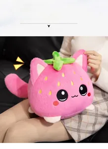 Detailed view of the strawberry cat plush toy held on lap showing the soft cotton fabric