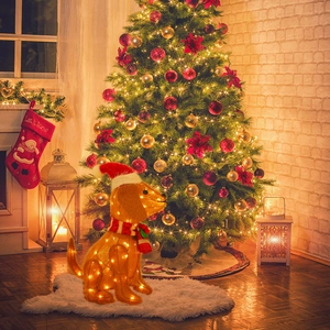 Detail of a lighted golden dachshund Christmas decor with red hat and striped scarf
