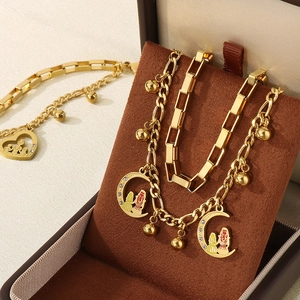 Detailed view of golden heart and moon necklace set in a premium velvet gift box