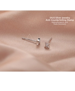 Macro detail of S925 sterling silver four-point star earring with S925 hallmark