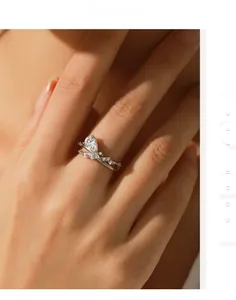 Detail of s925 silver ring featuring a pear-cut diamond and elegant criss-cross design