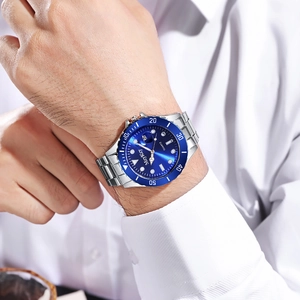 Classic silver stainless steel men's watch with deep blue dial on wrist