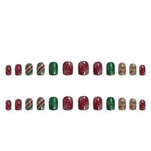 Christmas press-on nails featuring red snowflake patterns and green glitter candy theme