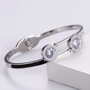 Polished silver titanium bangle with Roman numeral motifs and brilliant zircon stones