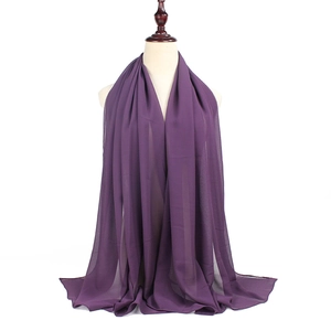 Detail showing the elegant drape and soft chiffon texture of the purple hijab on a mannequin